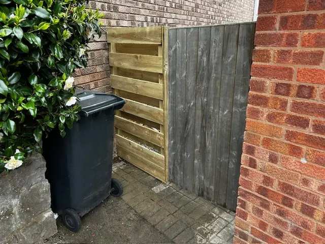 Timber side gate fitted between brick walls. One of our jobs.