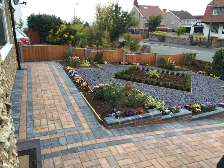 Two-tone block paved drive with gravel beds and flower borders edged in blocks. One of our jobs.